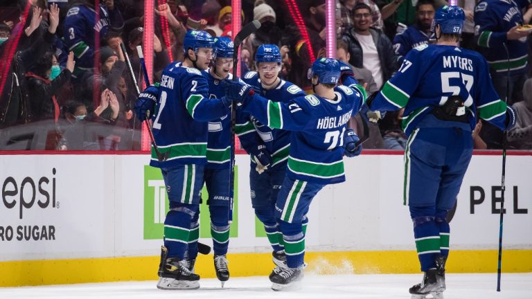 Vancouver Canucks' Luke Schenn, from left to right, Elias Pettersson, of Sweden, Vasily Podkolzin, of Russia, Nils Hoglander, of Sweden, and Tyler Myers celebrate Pettersson's goal against the Arizona Coyotes during the second period of an NHL hockey game in Vancouver, on Tuesday, February 8, 2022. (Darryl Dyck/CP)