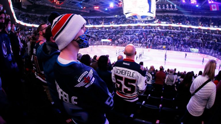 Winnipeg Jets fans take in first period NHL action against the Minnesota Wild in Winnipeg as they return to 100 per cent capacity for home games at Canada Life Centre on Wednesday, February 16, 2022. (John Woods/CP)