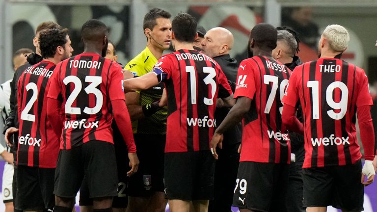 AC Milan's manager Stefano Pioli, center right, and his players argue with referee Matteo Marchetti, center left, end of a Serie A soccer match between AC Milan and Udinese, at the San Siro stadium. (Luca Bruno/AP)