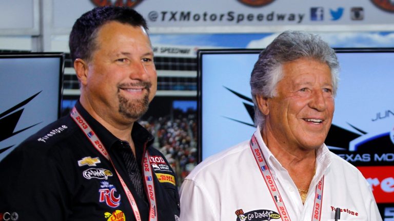 In this June 7, 2013, photo, Michael Andretti, left, and his father, Mario Andretti, pose for a photo following a news conference at Texas Motor Speedway in Fort Worth, Texas, June 7, 2013. Mario says Michael has filed paperwork with the FIA to start a new Formula One team. Andretti Autosport declined to comment on Mario's claim. Michael unsuccessfully tried to purchase an F1 team last year. (Tim Sharp/AP)