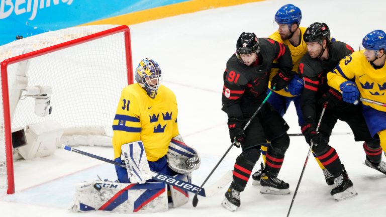 Team Canada forwards Jordan Weal (91) and Corban Knight (9) look for a rebound in front of Team Sweden goaltender Lars Johansson (31) during second period men's quarter-final hockey action at the Beijing Winter Olympics in Beijing, China, on Wednesday, Feb. 16, 2022. (Ryan Remiorz/CP) 