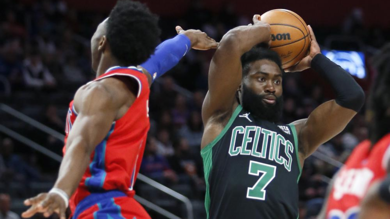 Boston Celtics guard Jaylen Brown (7) passes the ball while being guarded by Detroit Pistons guard Hamidou Diallo, left, during the first half of an NBA basketball game Saturday, Feb. 26, 2022, in Detroit. (AP)