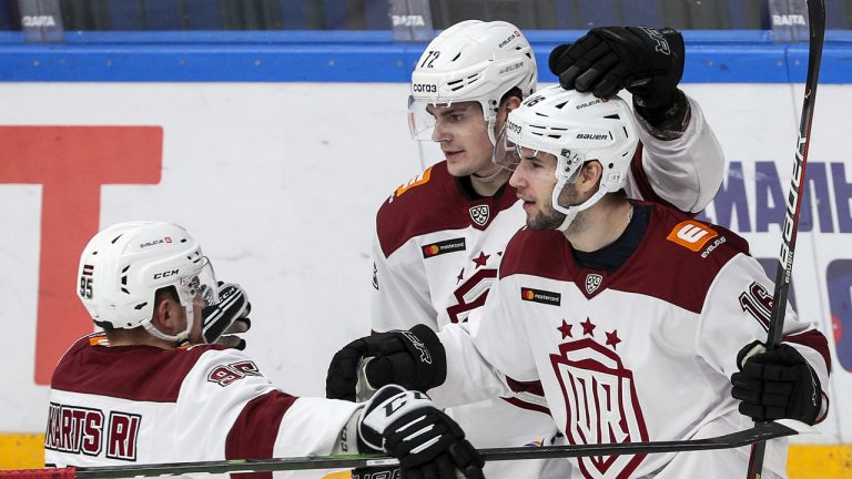 Dinamo's Roberts Bukarts, Janis Svanenbergs, and Martins Dzierkals (L-R) celebrate after scoring. (Gavriil Grigorov/TASS)