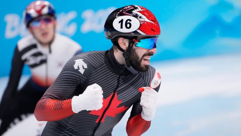 Canada's Steven Dubois reacts after winning the silver medal in the men's 1,500-metre short-track speedskating event at the Beijing Winter Olympics in Beijing, China, on Wednesday, Feb. 9, 2022. (Paul Chiasson/THE CANADIAN PRESS)