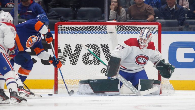 Andrew Hammond (37) of the Montreal Canadiens defends a scoring chance early during the second period from Anders Lee (27) of the New York Islanders at UBS Arena on Sunday, Feb. 20, 2022 in Elmont, N.Y. (Jim McIsaac/Newsday via AP)