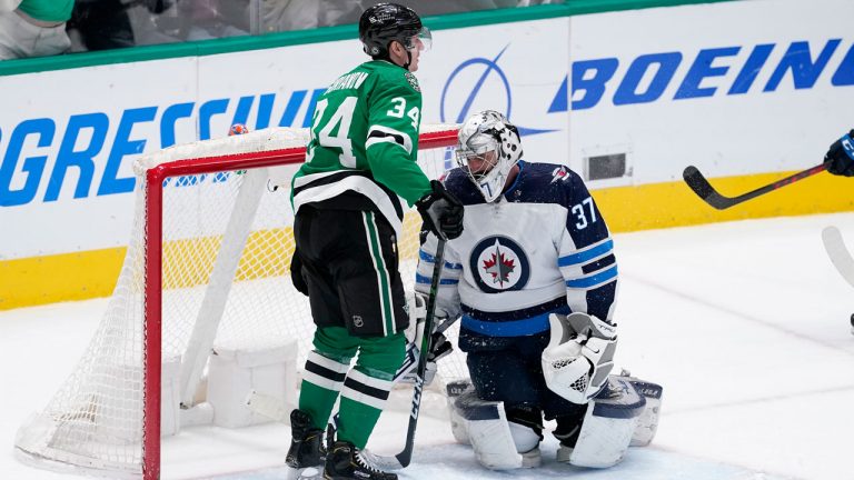 Dallas Stars right wing Denis Gurianov (34) stands by the net after scoring against Winnipeg Jets goaltender Connor Hellebuyck (37) in the third period of an NHL hockey game. (AP)