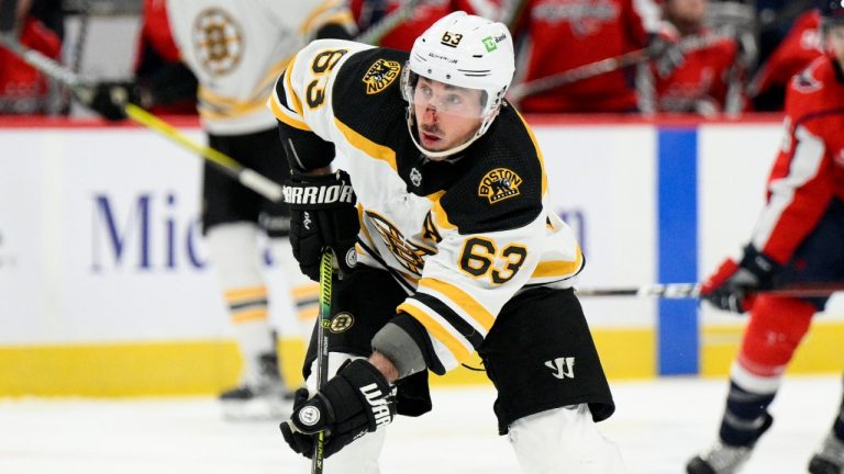 Boston Bruins left wing Brad Marchand (63) skates with the puck during the second period of an NHL hockey game against the Washington Capitals, Monday, Jan. 10, 2022, in Washington. (Nick Wass/AP)