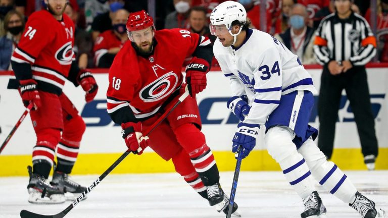 Toronto Maple Leafs' Auston Matthews (34) is pressured by Carolina Hurricanes' Derek Stepan (18) during the second period of an NHL hockey game in Raleigh, N.C., Monday, Oct. 25, 2021. (Karl B DeBlaker/AP)