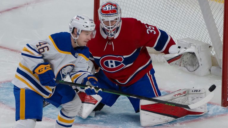 Buffalo Sabres left wing Brandon Biro (46) and Montreal Canadiens goalie Sam Montembeault watch the puck during first period NHL hockey action in Montreal on Wednesday, February 23, 2022. (Peter McCabe/CP)