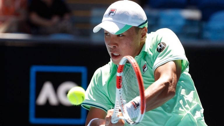 Brandon Nakashima of the U.S. plays a backhand return to Matteo Berrettini of Italy during their first round match at the Australian Open tennis championships in Melbourne, Australia, Monday, Jan. 17, 2022. (Hamish Blair/AP)