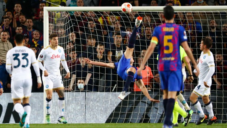 Barcelona's Luuk de Jong, center, performs a reverse kick during the Europa League soccer match between Barcelona and Napoli. (Joan Monfort/AP)