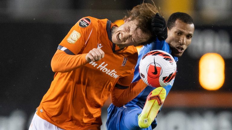 Hamilton Forge midfielder Alexander Achinioti-Jonsson (13) battles for a ball with Cruz Azul midfielder Romulo Otero (10) during the first half of the first leg of the 2022 CONCACAF Champions League Round of 16 at Tim Hortons Field in Hamilton, Ont., on Wednesday, February 16, 2022. (Nick Iwanyshyn/CP)