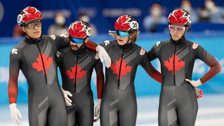 Canada’s Jordan Pierre-Gilles, left, Steven Dubois, second left, Kim Boutin, second right, Florence Brunelle, right, react after finishing fourth in the mixed team relay speed skating final Saturday, February 5, 2022 at the 2022 Winter Olympics in Beijing. (Ryan Remiorz/THE CANADIAN PRESS)