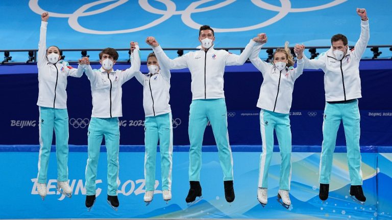 The team from the Russian Olympic Committee jumps on the podium during the victory ceremony, after the team event in the figure skating competition at the 2022 Winter Olympics, Monday, Feb. 7, 2022, in Beijing. (David J. Phillip/AP Photo)