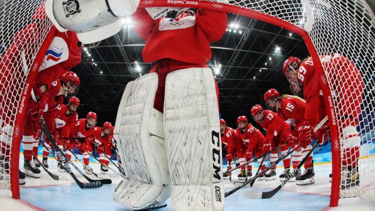 Russian Olympic Committee players gather around the net before a preliminary round women's hockey game against Switzerland at the 2022 Winter Olympics, Friday, Feb. 4, 2022, in Beijing. (Bruce Bennett/Pool Photo via AP)