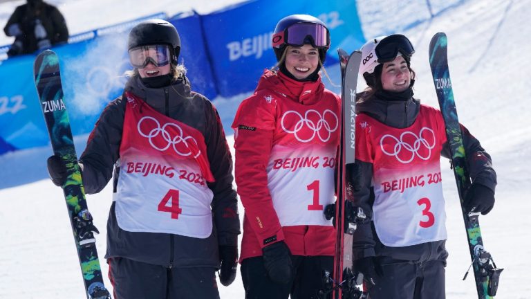 From left silver medal winner Canada's Cassie Sharpe, gold medal winner China's Eileen Gu and bronze medal winner Canada's Rachael Karker celebrate after the women's halfpipe finals at the 2022 Winter Olympics. (Lee Jin-man/AP)