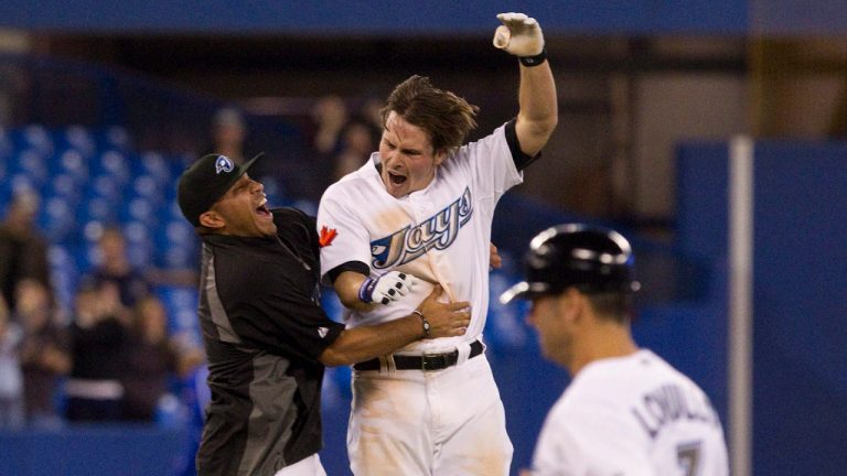 Toronto Blue Jays' Travis Snider jumps into the arms of Ricky Romero after hitting a double to deep centre to bring in Edwin Encarncion to beat New York Yankees 6-5 during the tenth inning of AL baseball action in Toronto on Tuesday, April 19, 2011. (Chris Young/CP) 