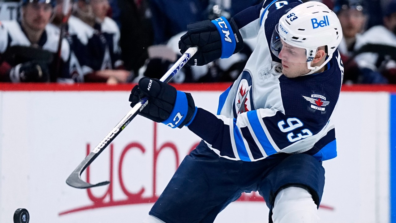 Winnipeg Jets left wing Kristian Vesalainen (93) slaps he puck in the air during the second period against the Colorado Avalanche in an NHL hockey game Thursday, Jan. 6, 2022, in Denver. (Jack Dempsey/AP)