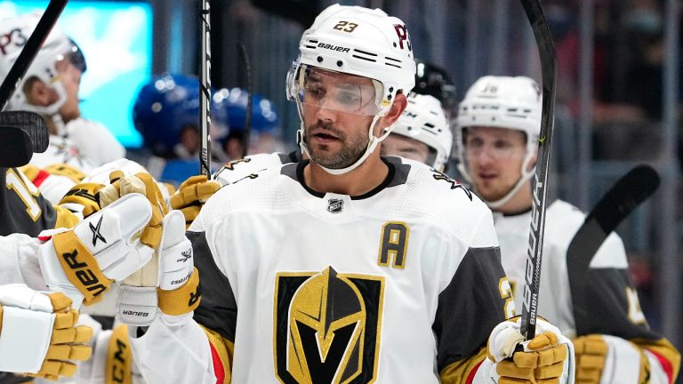 Vegas Golden Knights defenceman Alec Martinez (23) celebrates a goal against the Colorado Avalanche with teammates on the bench during the first period of a preseason NHL hockey game Tuesday, Oct. 5, 2021, in Denver. (Jack Dempsey/AP)