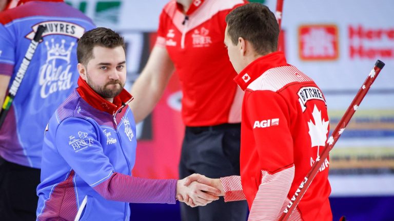 Team Wild Card Two skip Matt Dunstone, left, shakes hands with Team Canada skip Brendan Bottcher after losing to him at the Tim Hortons Brier in Lethbridge, Alta., Wednesday, March 9, 2022. (Jeff McIntosh/THE CANADIAN PRESS)