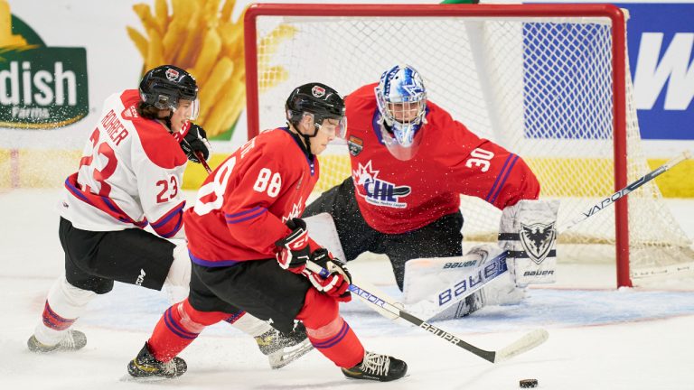 David Goyette, of the Sudbury Wolves, steers the puck away from his team red goaltender Ivan Zhigalov, of the Sherbrooke Phoenix, as Vinzenz Rohrer, of the Ottawa 67’s, forechecks during the 2022 Kubota CHL/NHL Top Prospects game in Kitchener, Ontario on Wednesday, March 23, 2022.
(Geoff Robins/CP)