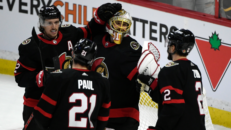 Ottawa Senators goaltender Anton Forsberg (31) celebrates the team’s win against the Tampa Bay Lightning with Thomas Chabot (72), Nick Paul (21), and Artem Zub (2) in Ottawa, on Saturday, Dec. 11, 2021. (CP)