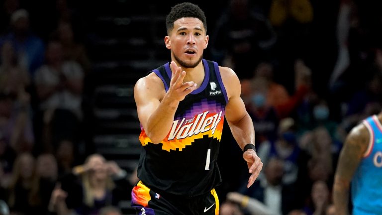 Phoenix Suns guard Devin Booker motions after making a three pointer. (Matt York/AP)