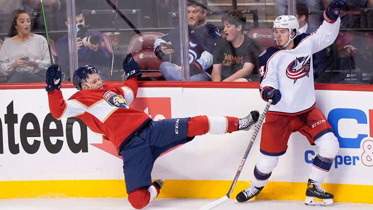 Columbus Blue Jackets center Cole Sillinger, right, slams Florida Panthers defenseman Olli Juolevi into the boards during the second period of an NHL hockey game, Thursday, Feb. 24, 2022, in Sunrise, Fla. (Wilfredo Lee/AP)