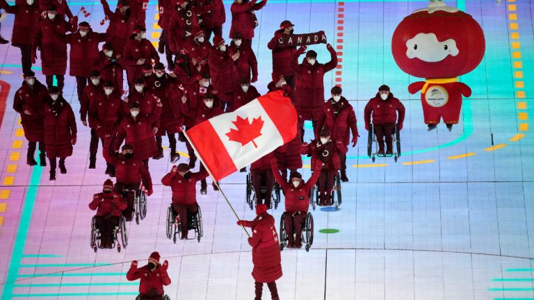 Team Canada make their entrance during the opening ceremony at the 2022 Winter Paralympics. (Dita Alangkara/AP)