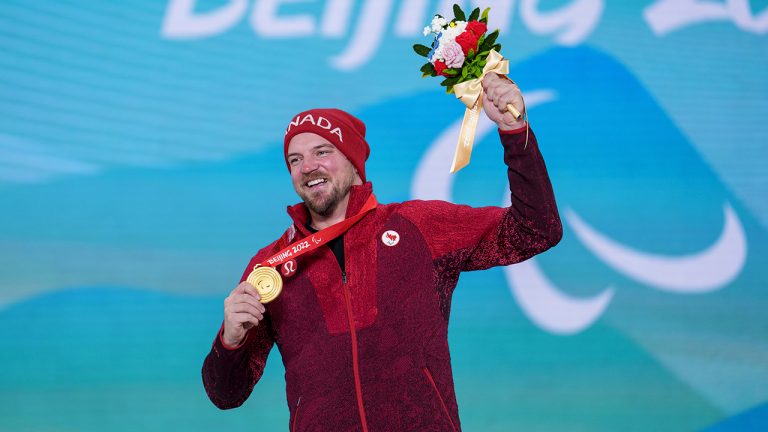 Tyler Turner, of Canada, shows his gold medal for the Para Snowboard Men's Snowboard Cross SB-LL1 during medal ceremonies for the Beijing 2022 Winter Paralympic Games in Zhangjiakou, China, Monday, March 7, 2022. (Thomas Lovelock/OIS/IOC via AP)