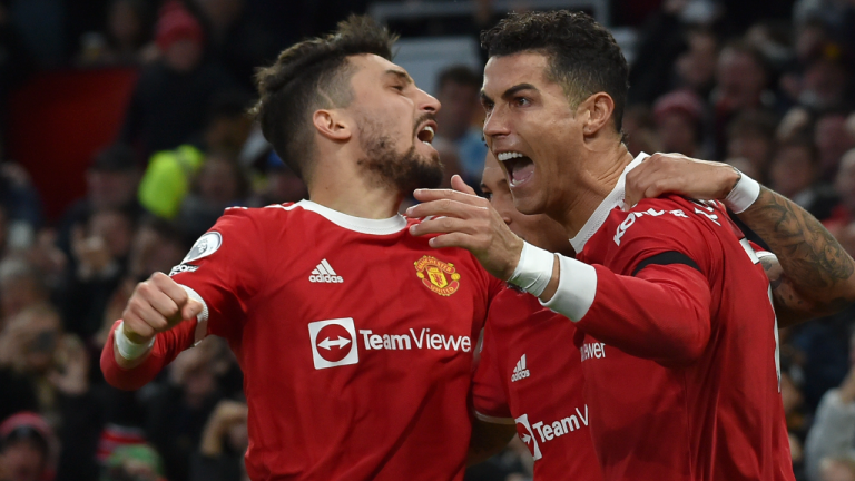 Manchester United's Cristiano Ronaldo, right, celebrates with teammates after scoring his side's second goal during the English Premier League soccer match between Manchester United and Tottenham Hotspur, at the Old Trafford stadium in Manchester, England, Saturday, March 12, 2022. (AP)