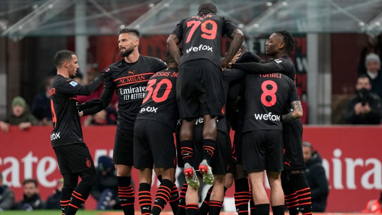 AC Milan players celebrate after Pierre Kalulu scored the opening goal against Empoli at the San Siro  (Antonio Calanni/AP)