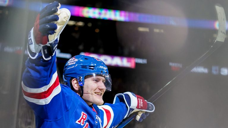 New York Rangers defenseman Adam Fox celebrates after scoring the game winning goal in overtime against the Anaheim Ducks. (John Minchillo/AP)