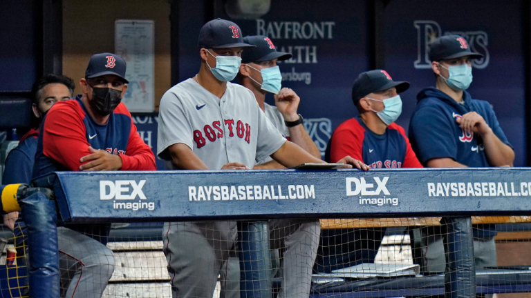 Boston Red Sox manager Alex Cora, left, and other members of the coaching staff wear protective masks during the fourth inning of a baseball game against the Tampa Bay Rays on Monday, Aug. 30, 2021, in St. Petersburg, Fla. (AP/file)