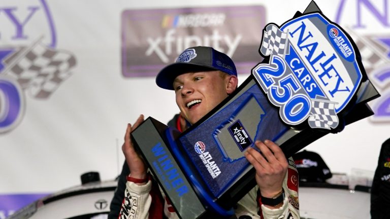 Ty Gibbs holds the trophy after winning the NASCAR Xfinity Series auto race at Atlanta Motor Speedway. (John Bazemore/AP)