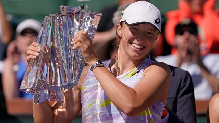 Iga Swiatek, of Poland, smiles as she holds her trophy after defeating Maria Sakkari, of Greece, in the women's singles finals at the BNP Paribas Open tennis tournament Sunday, March 20, 2022, in Indian Wells, Calif. Swiatek won 6-4, 6-1. (Mark J. Terrill/AP)