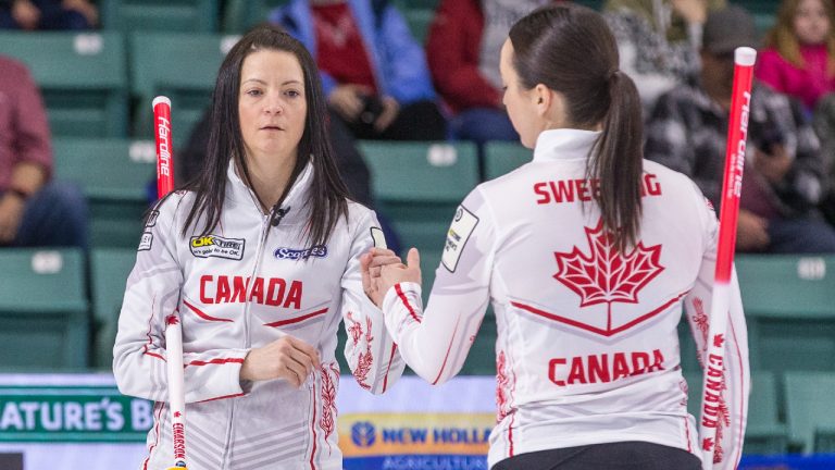 Team Canada skip Kerri Einarson, fist bumps third Val Sweeting at CN Centre during at the Women's World Curling Championship. (James Doyle/CP)