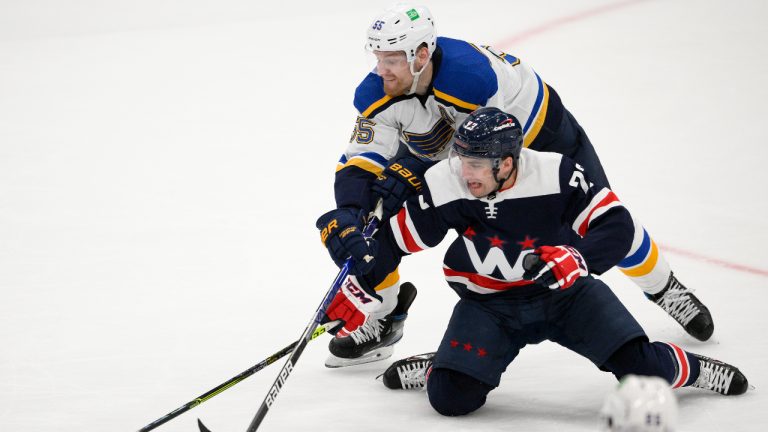 St. Louis Blues defenseman Colton Parayko (55) and Washington Capitals left wing Conor Sheary (73) compete for the puck during the third period of an NHL hockey game, Tuesday, March 22, 2022, in Washington. The Blues won 5-2. (AP Photo/Nick Wass)