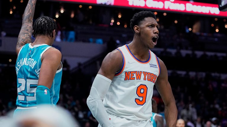 New York Knicks guard RJ Barrett (9) celebrates a basket after drawing a foul by Charlotte Hornets forward P.J. Washington, left, during the second half of an NBA basketball game Wednesday, March 23, 2022, in Charlotte, N.C. (Rusty Jones/AP)