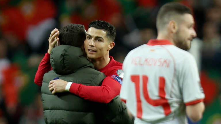 Portugal's Cristiano Ronaldo, center, celebrates at the end of the World Cup 2022 playoff soccer match between Portugal and North Macedonia, at the Dragao stadium in Porto, Portugal, Tuesday, March 29, 2022. Portugal won 2-0. (AP)