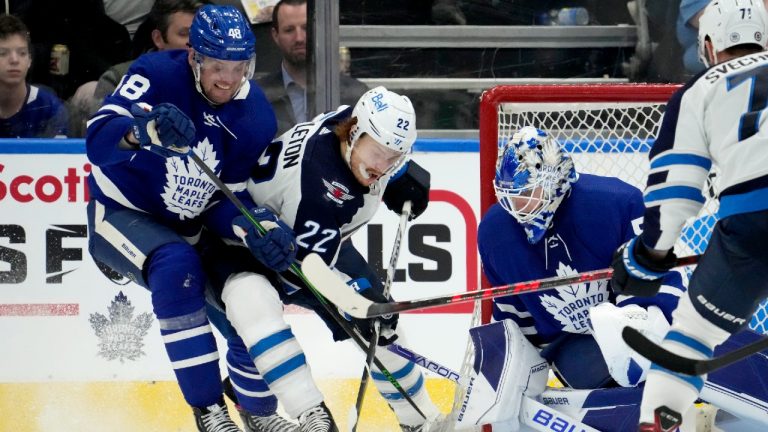 Toronto Maple Leafs goaltender Erik Kallgren (50) looks on as teammate Carl Dahlstrom (48) and Winnipeg Jets centre Mason Appleton (22) vie for control of the puck beside the crease during second period NHL hockey action in Toronto, Thursday, March 31, 2022. (Frank Gunn/CP)