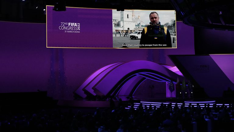 Andriy Pavelko, head of Ukrainian soccer federation speaks during recorded message, wearing an armored vest from the streets of Kyiv, during the 2022 soccer World Cup draw at the Doha Exhibition and Convention Center. (Hassan Ammar/AP)