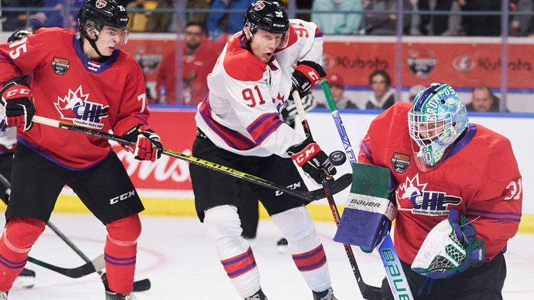 Team White’s Nathan Gaucher of the Quebec Remparts tries to tip the puck past Team Red goalie Reid Dyck of the Swift Current Broncos during the 2022 Kubota CHL/NHL Top Prospects game. (Geoff Robins/CP)