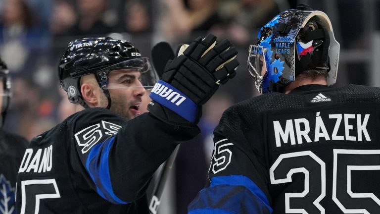 Toronto Maple Leafs defenceman Mark Giordano (55) and Leafs goaltender Petr Mrazek (35) celebrate their win over the New Jersey Devils after NHL hockey action in Toronto, Wednesday March 23, 2022. Giordano was making his Maple Leafs debut. (Frank Gunn/THE CANADIAN PRESS)