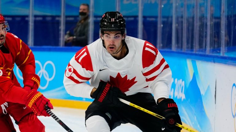 Canada's Jack McBain (11) moves the puck ahead during a preliminary round men's hockey game at the 2022 Winter Olympics, Sunday, Feb. 13, 2022, in Beijing. (AP Photo/Matt Slocum)