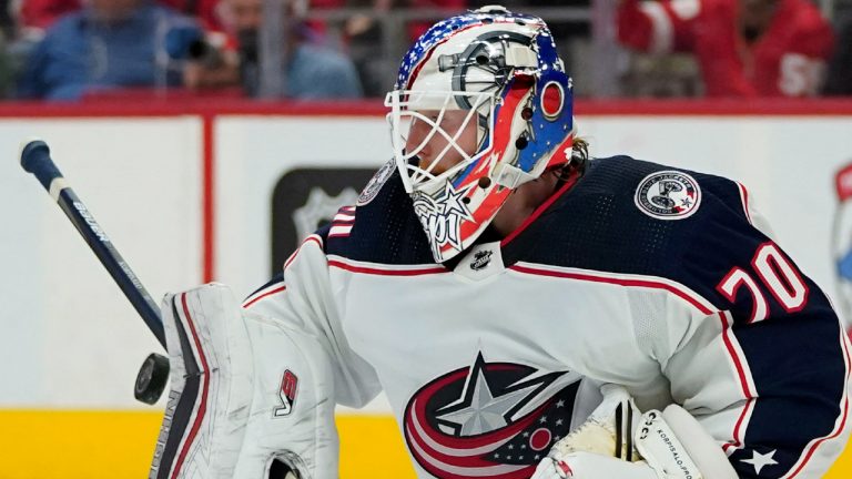 Columbus Blue Jackets goaltender Joonas Korpisalo (70) deflects a Detroit Red Wings shot in the second period of an NHL hockey game Tuesday, Oct. 19, 2021, in Detroit. (Paul Sancya/AP)