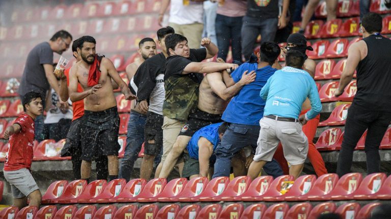 Fans clash during a Mexican soccer league match between the host Queretaro and Atlas from Guadalajara, at the Corregidora stadium, in Queretaro, Mexico, Saturday, March 5, 2022. Multiple people were injured in the brawl, including two critically. (Sergio Gonzalez/AP)