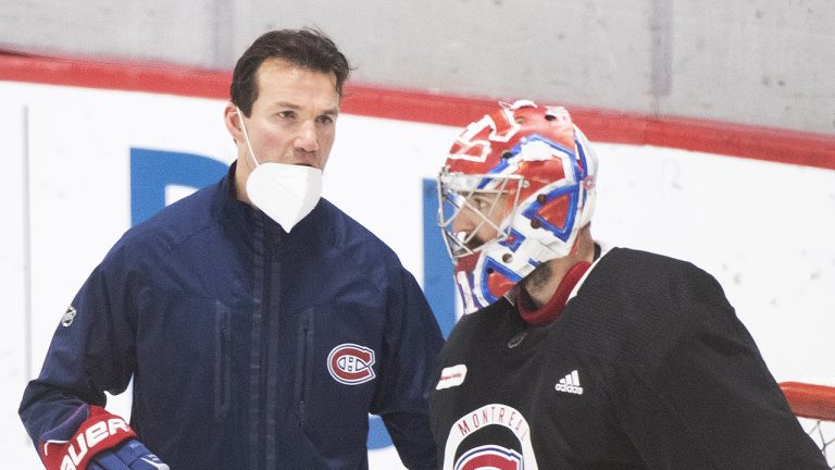 Montreal Canadiens replacement interim head coach Luke Richardson, left, talks with goaltender Carey Price during practice in Brossard, Que., south of Montreal. (Graham Hughes/CP)