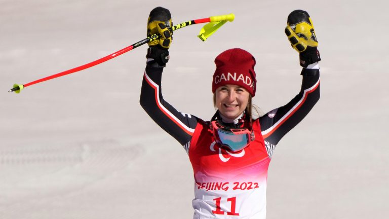 Gold medalist Mollie Jepsen of Canada waves to spectators during a flower ceremony for the women's downhill, standing, at the 2022 Winter Paralympics, Saturday, March 5, 2022, in the Yanqing district of Beijing. (Andy Wong/AP)