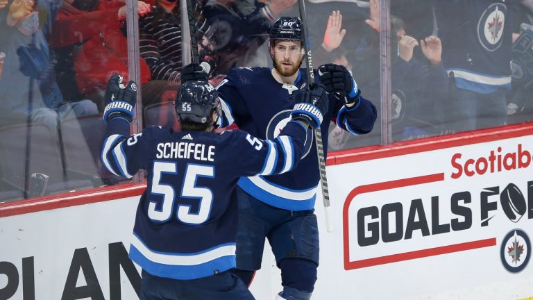 Winnipeg Jets' Mark Scheifele (55) and Pierre-Luc Dubois (80) celebrate Dubois' goal against the Tampa Bay Lightning during third period NHL action in Winnipeg on Tuesday, March 8, 2022. (Fred Greenslade/THE CANADIAN PRESS)